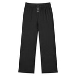 Black wide-leg lounge pants with an elastic waistband and three white buttons at the front, shown flat on a white background.