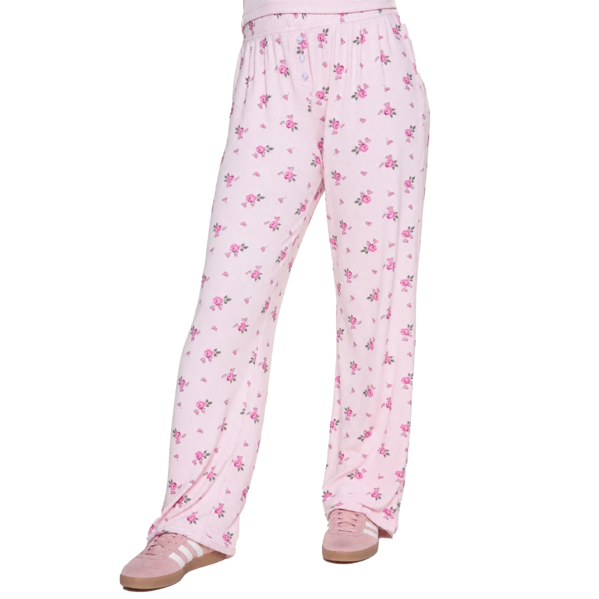 Pink floral lounge pants with a small-scale pink and green flower print, shown on a model from the waist down wearing pink sneakers against a white background.