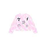 A pink tie-dye long-sleeve crop sweatshirt with black and white graphic prints including hearts, a star, a lightning bolt, a rainbow, and a sun on the front, displayed flat against a white background.