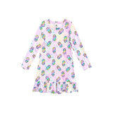A long-sleeve baby dress with a ruffled hem, featuring an all-over print of colorful ring pops on a pastel pink and iridescent background.