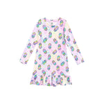 A long-sleeve baby dress with a ruffled hem, featuring an all-over print of colorful ring pops on a pastel pink and iridescent background.