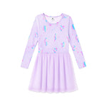 A girls' long-sleeve dress in light lavender purple with a colorful unicorn and heart print on the bodice, featuring a flared skirt, shown against a plain white background.