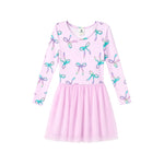 A girls' long-sleeve dress in light pink with an allover bow print in pastel shades of blue, purple, and green, featuring a gathered tulle skirt.