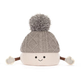 A cute, smiling marshmellow knit pom-pom hat with a gray cable-knit top section, a cream-colored bottom section, and small brown arms ending in cream mittens, shown on a solid white background.
