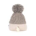 A cable-knit beanie hat in taupe gray with a fluffy gray pom-pom on top and a ribbed cream-colored cuff, shown against a plain white background.