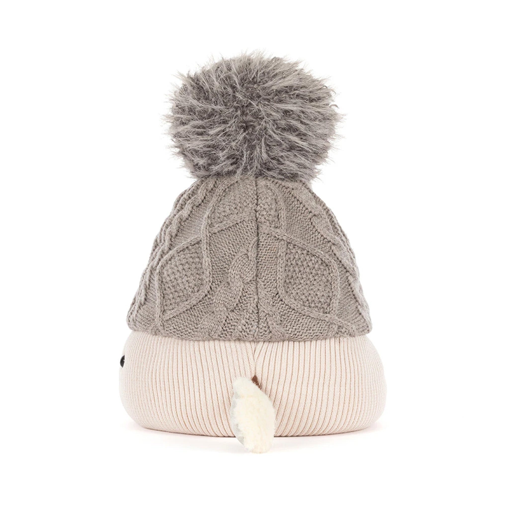 A cable-knit beanie hat in taupe gray with a fluffy gray pom-pom on top and a ribbed cream-colored cuff, shown against a plain white background.