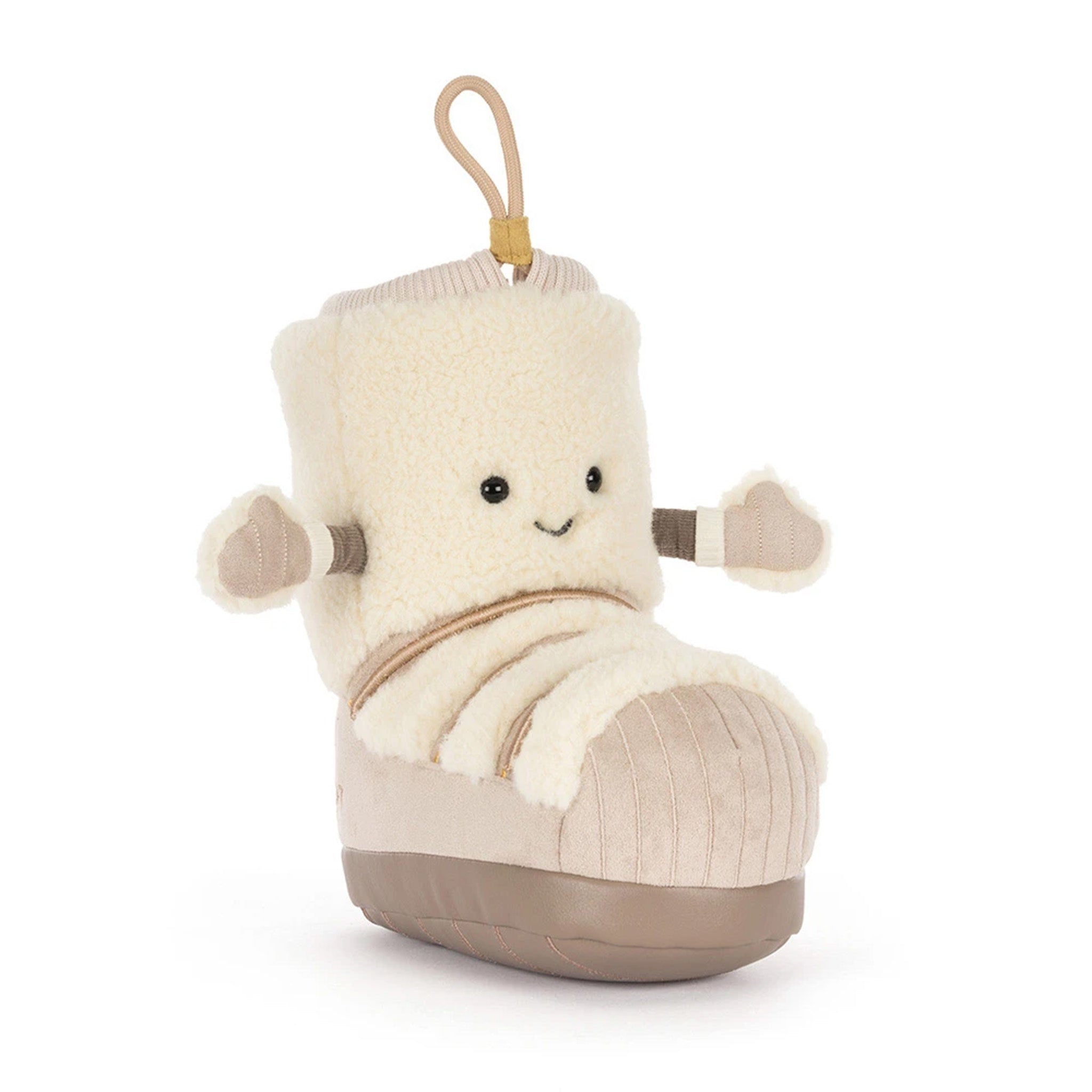 A plush boot-shaped toy or pillow with a cream sherpa upper, beige corduroy-like lower section, and a small hanging loop at the top, shown on a clean white background.