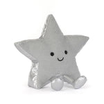A silver glittery star-shaped plush pillow with a cute embroidered face, sitting on a white background.