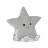A silver glittery star-shaped plush pillow with a cute embroidered face, sitting on a white background.