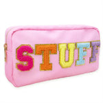 A pink zippered pouch featuring the word 'STUFF' in large, colorful, textured letters outlined in gold, set against a plain white background.