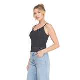 A woman modeling a black lace-trimmed camisole tank top paired with light-wash blue jeans, photographed against a solid white background.