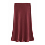 A satin slip skirt in a deep burgundy red, displayed against a solid white background.