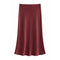 A satin slip skirt in a deep burgundy red, displayed against a solid white background.