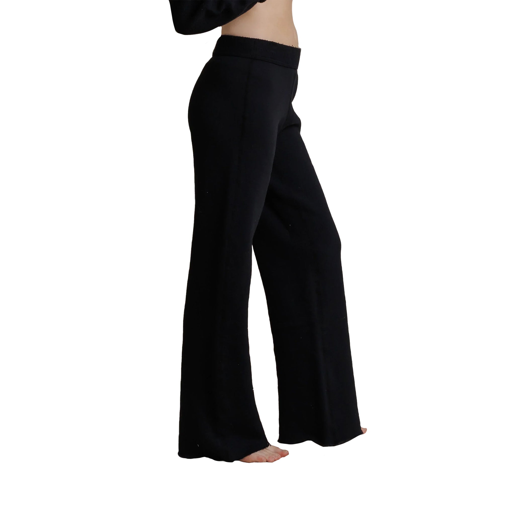 Black wide-leg pants shown on a model from the side, featuring a high waistband and flowing silhouette, against a plain white background.