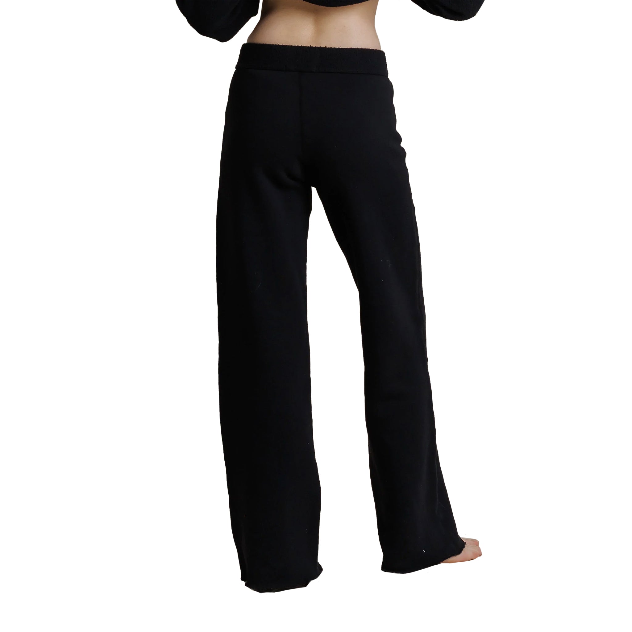 Black wide-leg pants shown from the back on a model, featuring a simple elastic waistband and straight, relaxed legs.