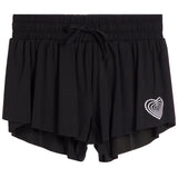Black double-layered ruffled shorts with an elastic drawstring waist and a white heart pattern on the lower left leg, shown against a plain white background.