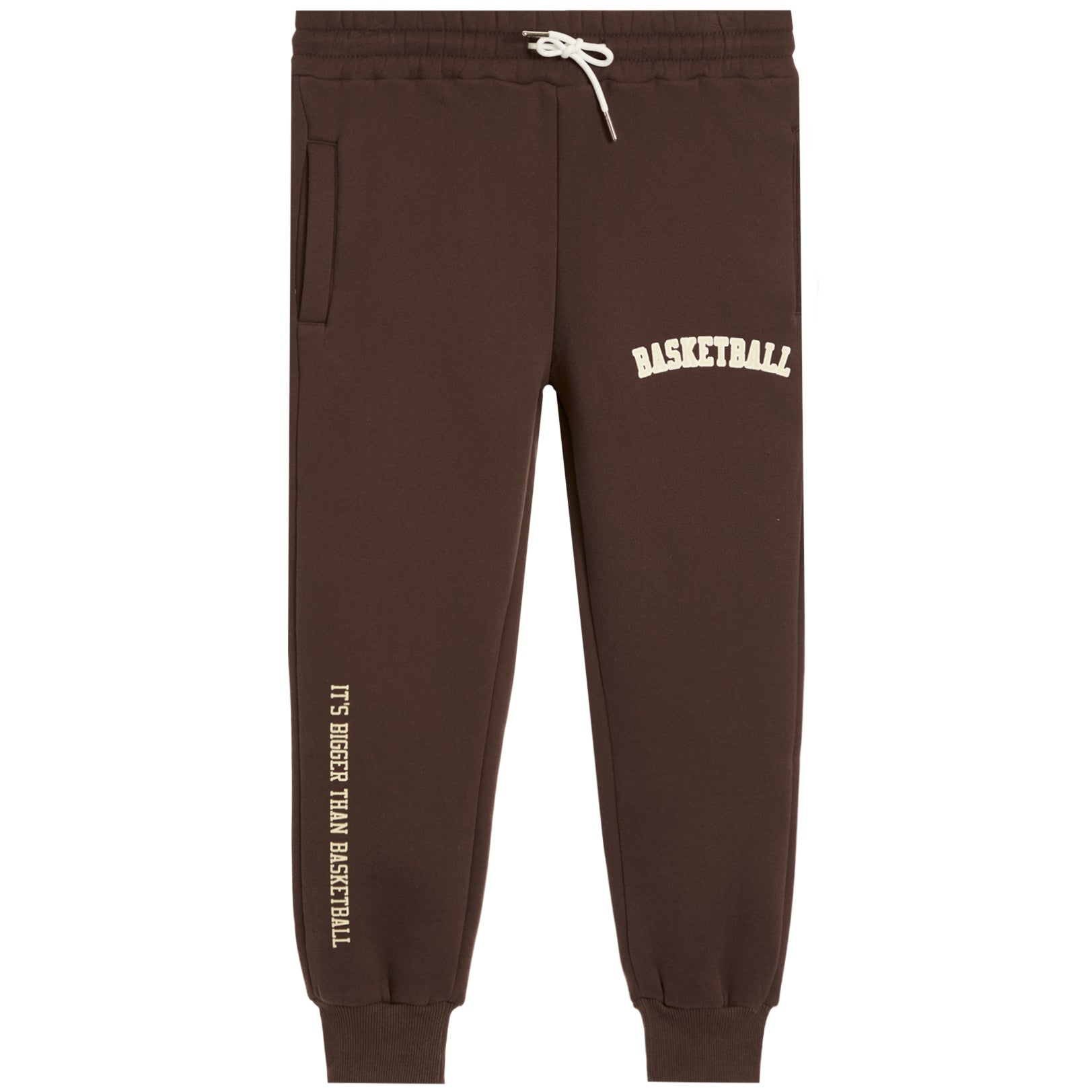 Dark brown sweatpants with white drawstrings, featuring 'BASKETBALL' printed in white on the upper right thigh and 'IT'S BIGGER THAN BASKETBALL' printed vertically in white on the lower left leg.