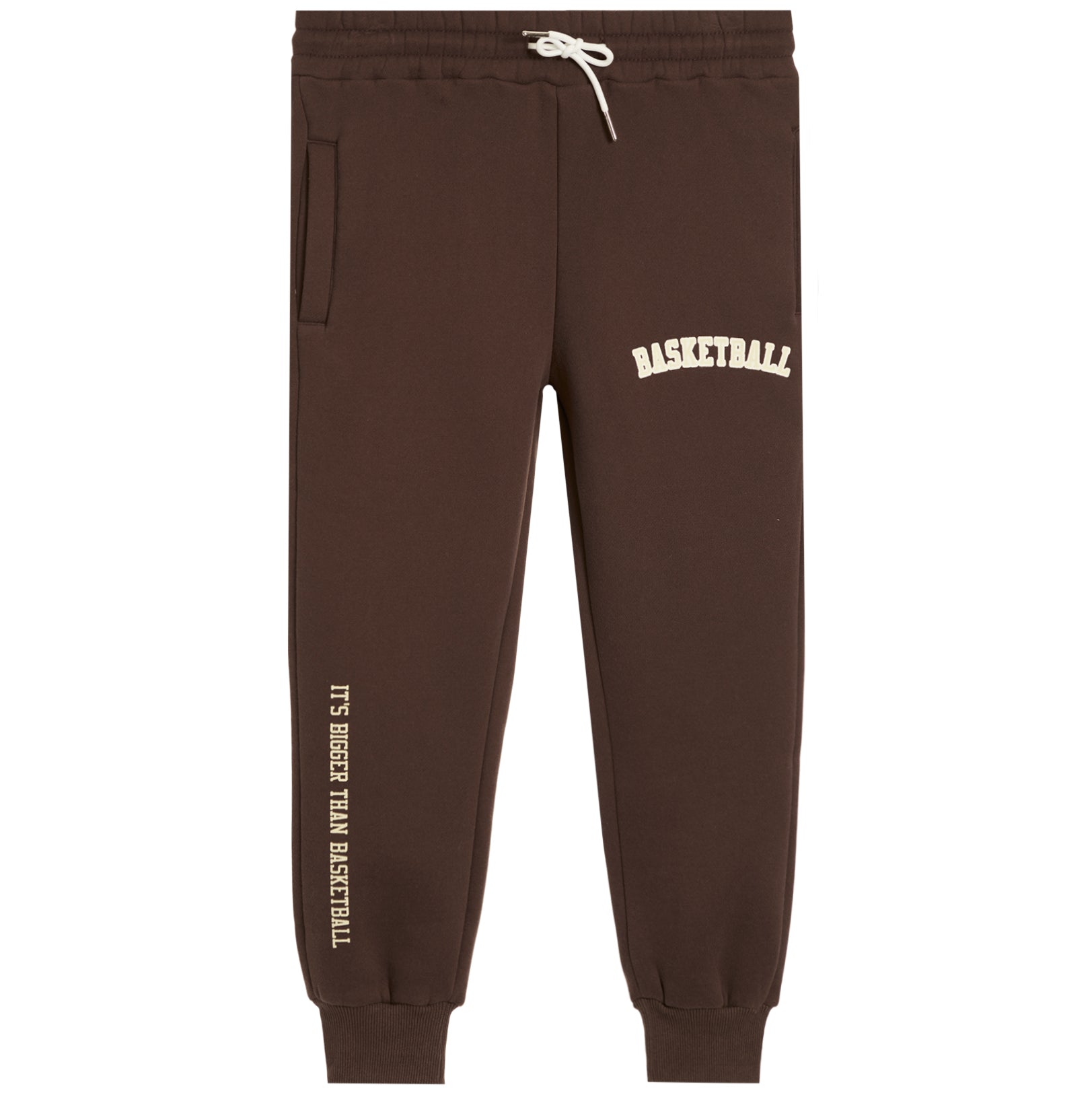 Dark brown sweatpants with white drawstrings, featuring 'BASKETBALL' printed in white on the upper right thigh and 'IT'S BIGGER THAN BASKETBALL' printed vertically in white on the lower left leg.