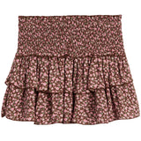 A smocked tiered ruffle mini skirt with a pink and brown floral pattern, shown flat against a white background.