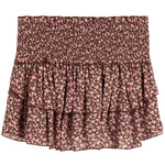 A smocked ruffled skirt with a pink and brown floral pattern, displayed flat against a white background.