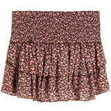 A smocked ruffled skirt with a pink and brown floral pattern, displayed flat against a white background.