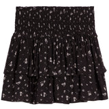 A black tiered ruffle mini skirt with a small white floral print, featuring a smocked elastic waistband.