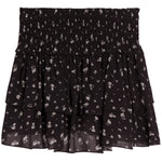 A black tiered ruffle mini skirt with a small white floral pattern, featuring a smocked elastic waistband.