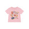 A light pink short-sleeve baby t-shirt with a colorful travel-themed graphic print featuring postage stamps, flowers, and a butterfly on a white background.