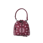 A burgundy drawstring bucket bag with a white floral bandana print, featuring a top handle and a front zippered pocket, shown on a plain white background.