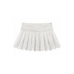 White eyelet tennis skirt with a pleated elastic waistband, shown flat on a white background.
