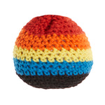 Colorful crocheted hackey sack with red, orange, yellow, blue, and black stripes on a white background.