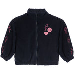 A black sherpa fleece zip-up jacket with pink embroidered lightning bolts on the sleeves and a pink heart-and-smiley patch on the chest, shown on a plain white background.