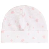 A white knit baby beanie hat with a soft pink heart pattern, featuring a folded cuff.
