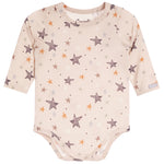 A long-sleeve baby bodysuit in a light beige/cream color, decorated with an all-over pattern of stars in brown, orange, and white. 