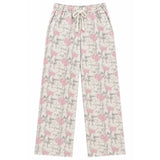 A pair of wide-leg pants featuring an all-over pink bow and gray branch pattern on a cream background, with a matching cream drawstring waistband.