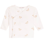 A baby long-sleeve wrap top in off-white, decorated with a pattern of small beige teddy bear faces. The top features an asymmetrical snap closure and is displayed flat against a solid white background.