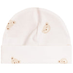 A soft cream-colored baby beanie hat featuring a repeating pattern of small teddy bear faces in beige and light brown, shown against a plain white background.