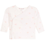 A baby long-sleeve wrap top in off-white with a delicate pink bow and heart pattern, shown flat against a white background.