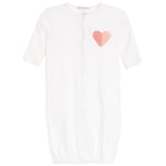 A white short-sleeve baby sleep sack with a pink textured heart applique on the chest, featuring a snap-button front closure and elasticized hem.