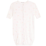 A baby sleep sack in white with a delicate pink bow and heart pattern, featuring short sleeves, a snap-button front, and an elasticated hem.