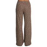 Wide-leg pants featuring a brown and beige leopard print pattern, shown on a model from the waist down against a plain white background.