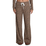 A person wearing leopard-print lounge pants with a white drawstring, shown from the waist down against a plain white background.