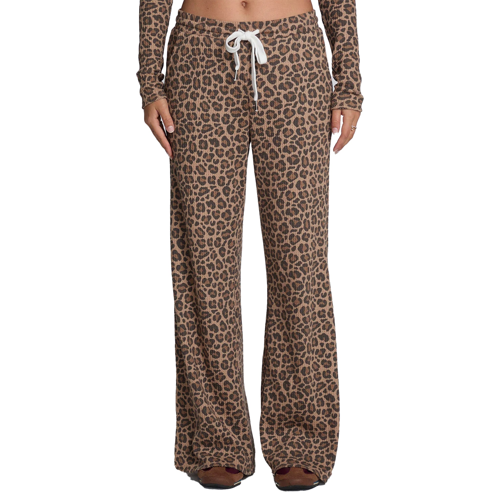 A person wearing leopard-print lounge pants with a white drawstring, shown from the waist down against a plain white background.
