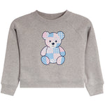 A heather gray long-sleeve crewneck sweatshirt for toddlers, featuring a central patchwork teddy bear graphic in pastel pink and blue tones.