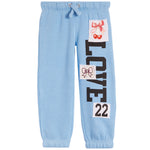 Light blue jogger sweatpants with a vertical 'LOVE' text print and decorative patchwork details on the left leg, including bows and the number '22'.