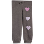 A pair of dark gray heather jogger pants featuring three textured, chenille lavender-pink hearts running down the right leg, with a matching gray heather drawstring waistband.