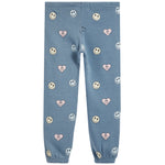 Light blue jogger pants with an all-over pattern of smiley faces and pink hearts, shown flat against a white background.