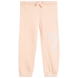 Light peach pink sweatpants with an elastic waistband, drawstring, and a white embroidered bow on the left leg, shown against a plain white background.