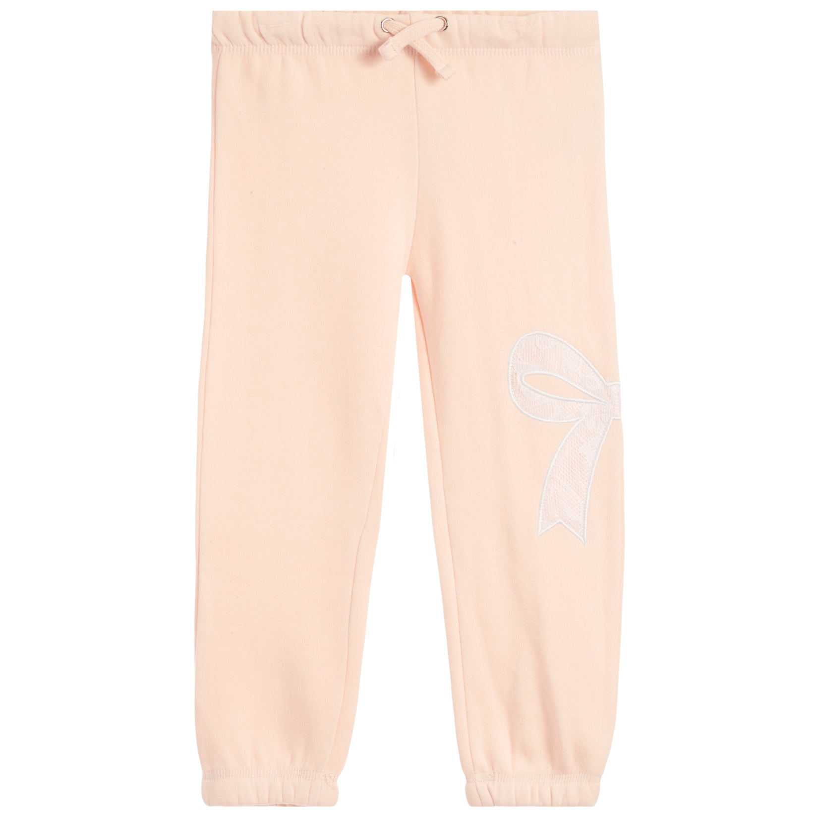 Light peach pink sweatpants with an elastic waistband, drawstring, and a white embroidered bow on the left leg, shown against a plain white background.