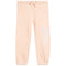 Light peach pink sweatpants with an elastic waistband, drawstring, and a white embroidered bow on the left leg, shown against a plain white background.